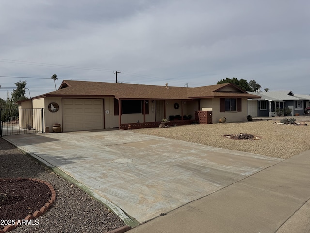 ranch-style home with concrete driveway and an attached garage