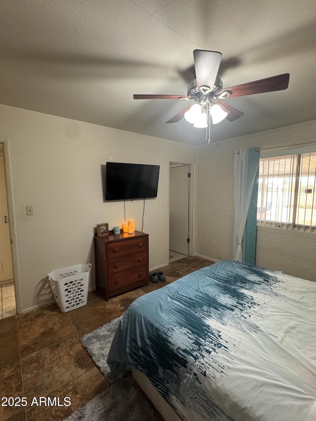 bedroom featuring a ceiling fan and a textured ceiling