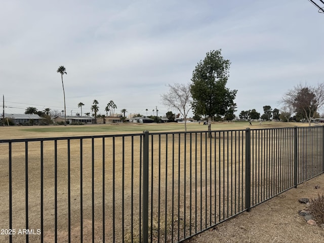 view of gate featuring fence and a yard