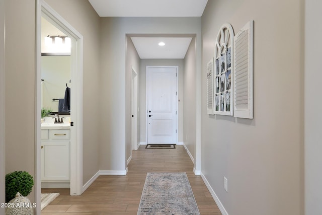 hall featuring sink and light hardwood / wood-style flooring