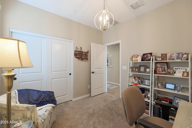 office area featuring light carpet and a chandelier