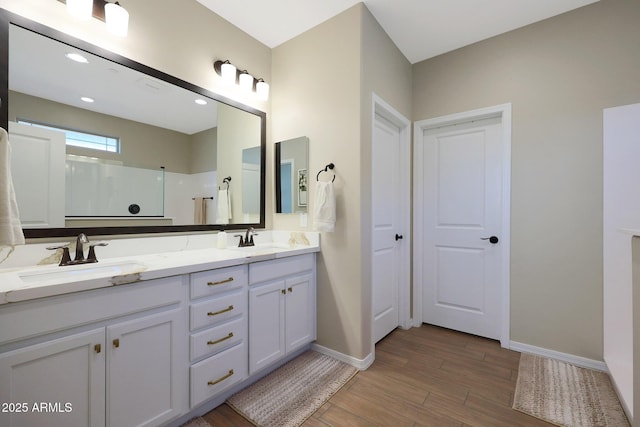 bathroom featuring vanity, hardwood / wood-style floors, and walk in shower