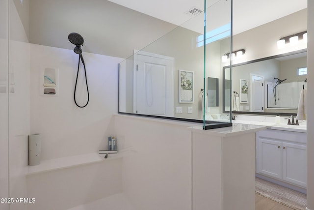 bathroom featuring vanity and walk in shower