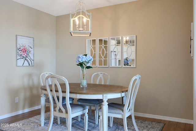 dining room with an inviting chandelier and hardwood / wood-style flooring