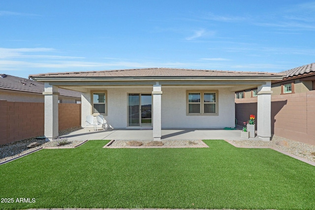 rear view of property with a patio and a lawn