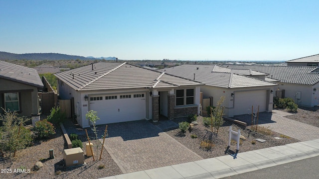 single story home with a mountain view and a garage