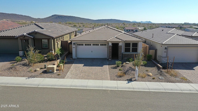 ranch-style house with a garage and a mountain view