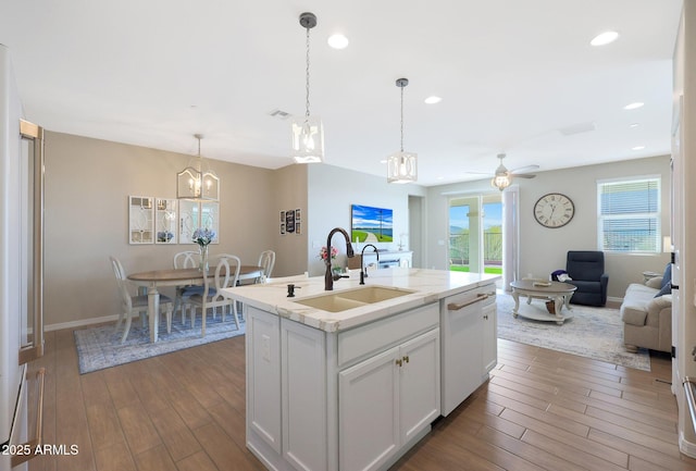 kitchen featuring sink, white cabinetry, a center island with sink, dishwasher, and light hardwood / wood-style floors