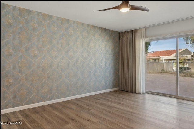 unfurnished room featuring hardwood / wood-style floors and ceiling fan