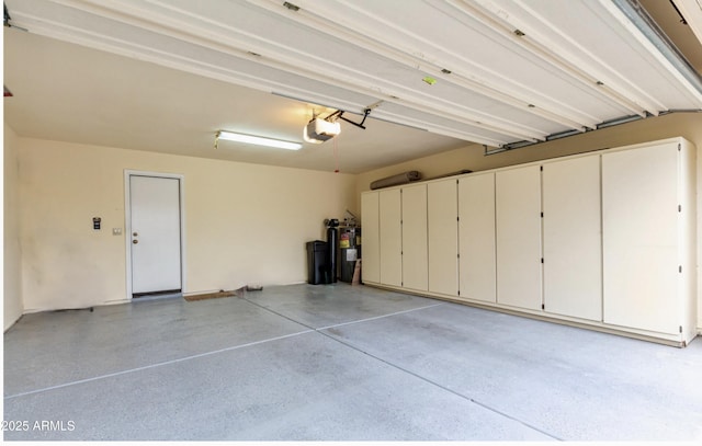 garage featuring a garage door opener and water heater