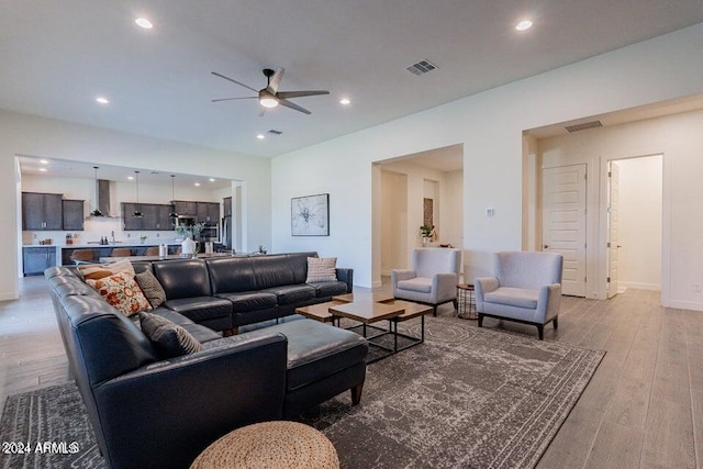 living room featuring light hardwood / wood-style floors and ceiling fan