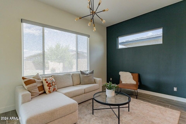 living room with wood-type flooring, plenty of natural light, and a chandelier