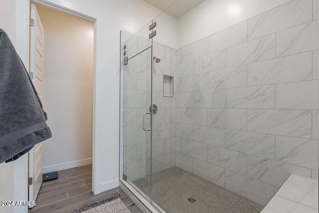 bathroom with a shower with shower door