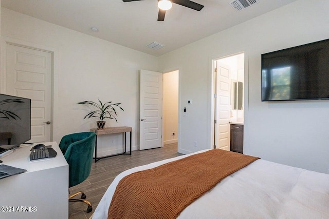 bedroom with light wood-type flooring, ceiling fan, and ensuite bathroom