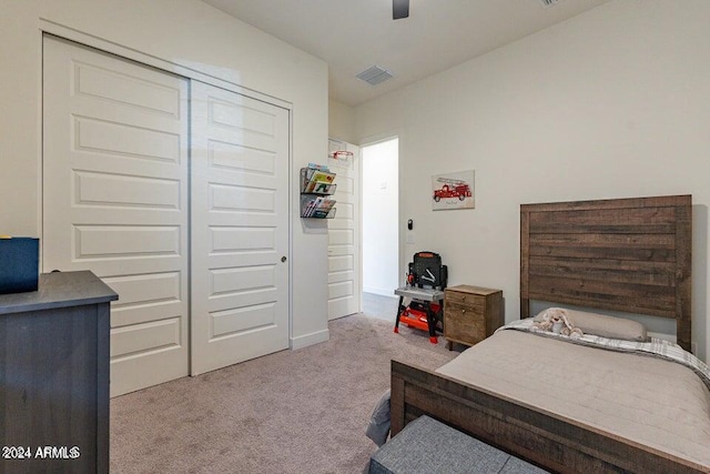 carpeted bedroom featuring a closet and ceiling fan