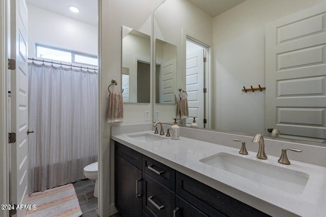 bathroom featuring vanity, walk in shower, toilet, and wood-type flooring