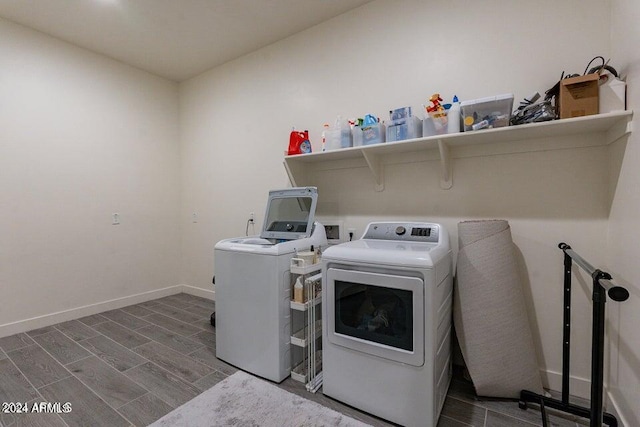 laundry area featuring washer and clothes dryer and hardwood / wood-style floors