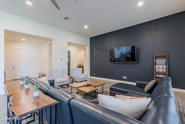 living room featuring hardwood / wood-style floors and ceiling fan