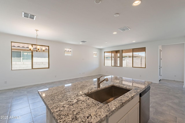 24184 W Gibson Ln, Buckeye, AZ 85326 - kitchen with open floor plan, plenty of natural light, dishwasher, decorative light fixtures, and recessed lighting