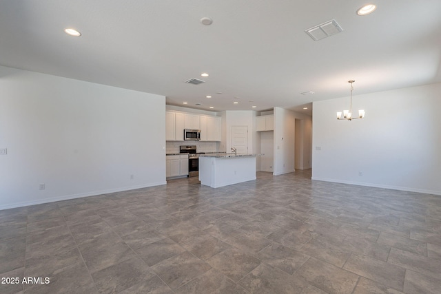 24184 W Gibson Ln, Buckeye, AZ 85326 - unfurnished living room featuring a chandelier and recessed lighting