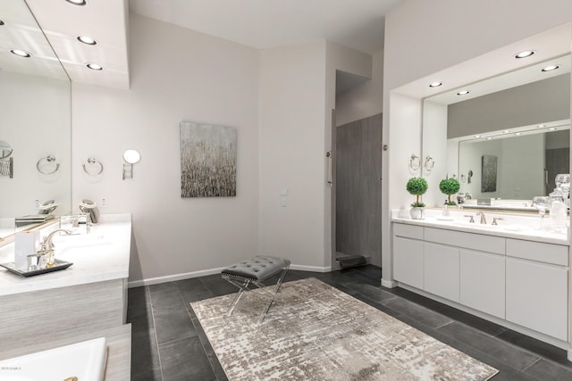 full bathroom with recessed lighting, baseboards, a bathtub, and two vanities