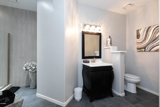 full bath with baseboards, toilet, vanity, and tile patterned flooring