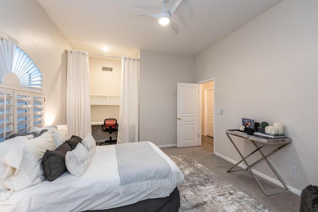 carpeted bedroom featuring visible vents, baseboards, ceiling fan, and a spacious closet