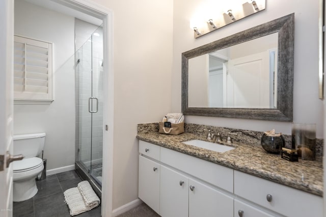 bathroom with tile patterned floors, toilet, a stall shower, baseboards, and vanity