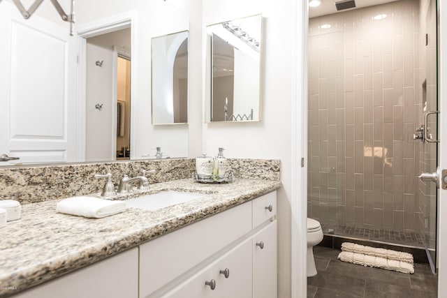 full bathroom featuring tile patterned floors, a stall shower, toilet, and vanity