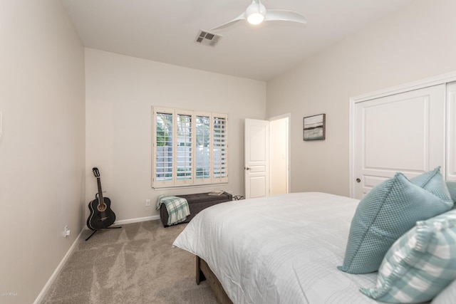 carpeted bedroom featuring visible vents, baseboards, and a ceiling fan