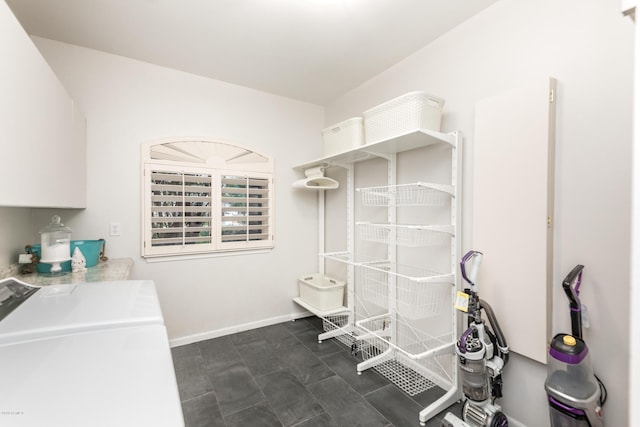 washroom with laundry area, separate washer and dryer, and baseboards