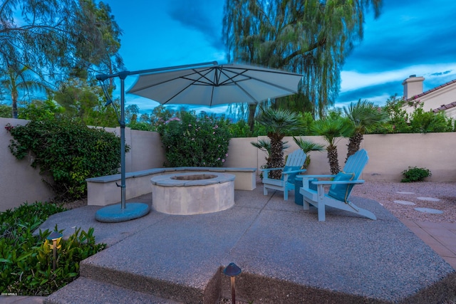 view of patio with a fenced backyard and an outdoor fire pit