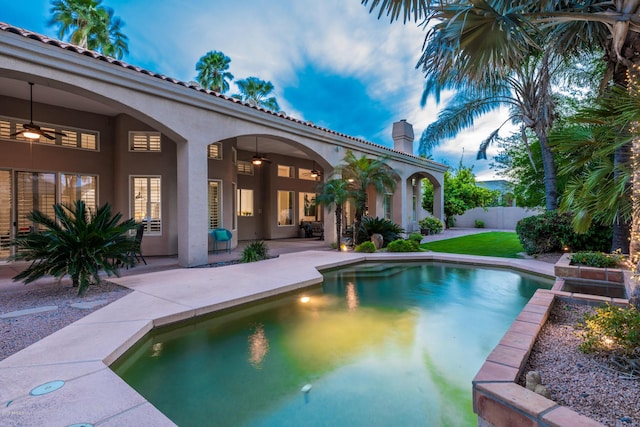 view of pool featuring a fenced in pool, fence, ceiling fan, and a patio area