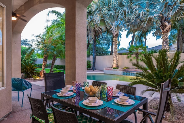 view of patio / terrace with outdoor dining area, a fenced in pool, and a fenced backyard