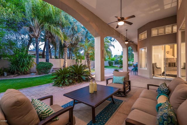 view of patio with outdoor lounge area, a ceiling fan, and fence