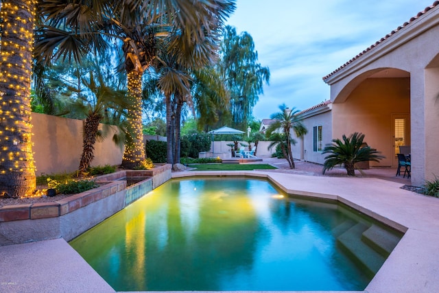 view of pool featuring a patio, a fenced backyard, and a fenced in pool