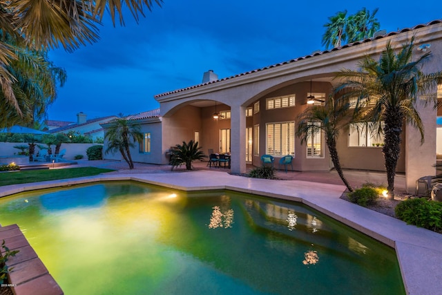 view of pool with a fenced in pool, a ceiling fan, and a patio