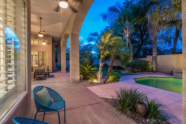 view of patio featuring fence and ceiling fan