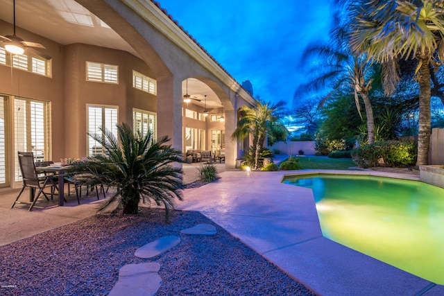 view of swimming pool with outdoor dining space, a ceiling fan, a patio, fence, and french doors