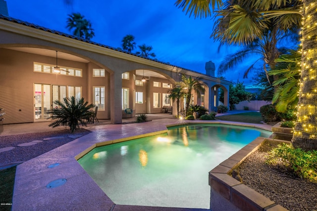 view of swimming pool featuring ceiling fan, a patio, and a fenced in pool