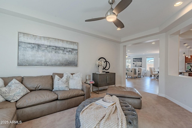 carpeted living room featuring ceiling fan