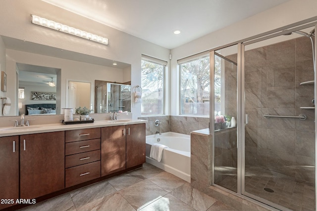 bathroom featuring vanity and independent shower and bath