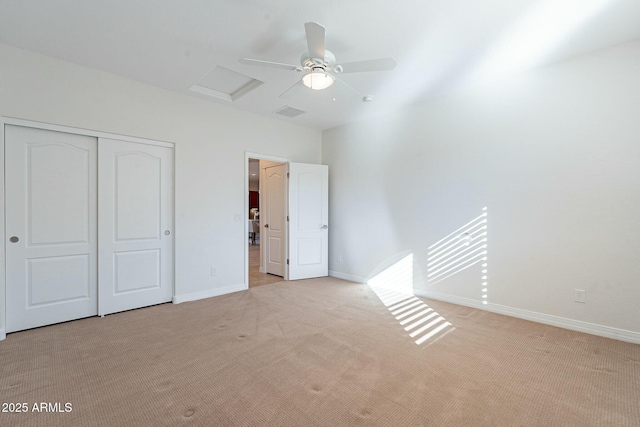 unfurnished bedroom featuring ceiling fan, a closet, and light carpet