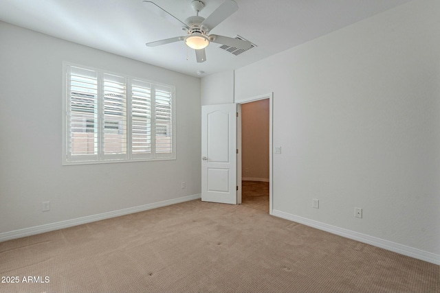 carpeted spare room with ceiling fan