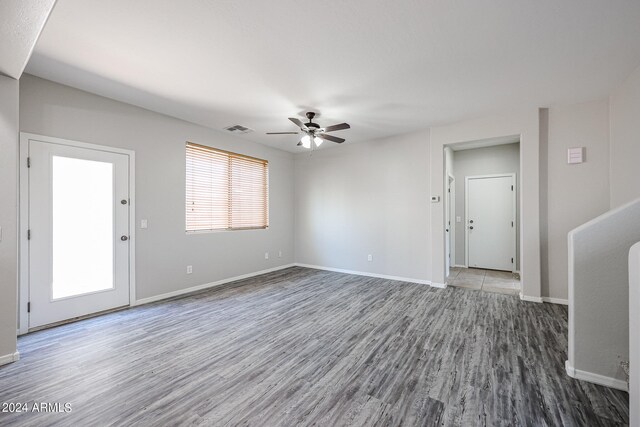 unfurnished living room featuring wood-type flooring and ceiling fan