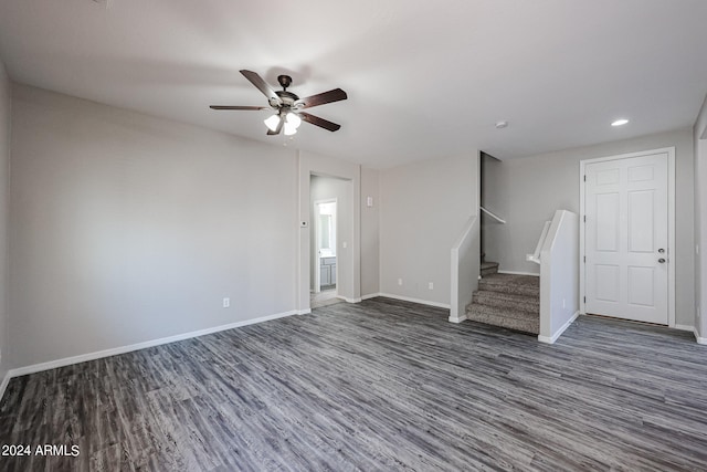 unfurnished living room featuring ceiling fan and dark hardwood / wood-style flooring