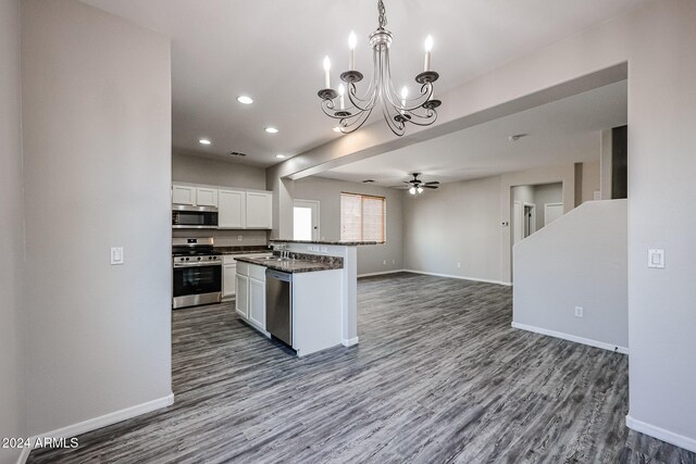 kitchen featuring white cabinets, pendant lighting, sink, appliances with stainless steel finishes, and dark hardwood / wood-style flooring