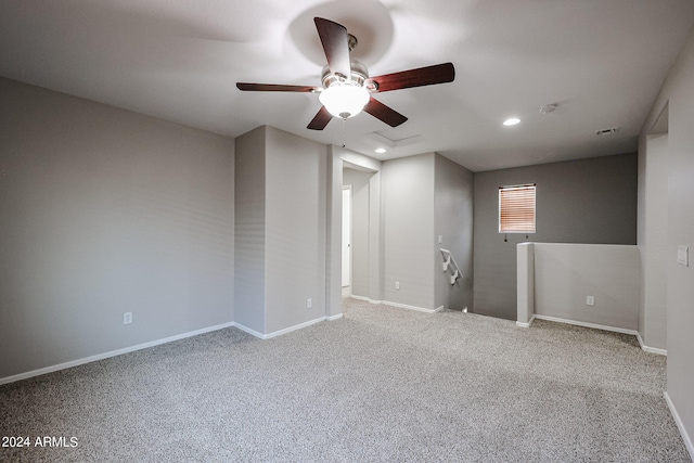 carpeted spare room featuring ceiling fan