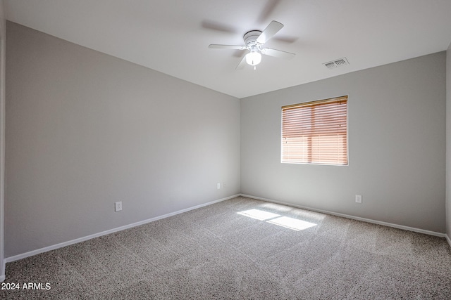 spare room with ceiling fan and carpet flooring