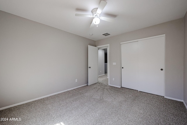 unfurnished bedroom featuring carpet floors, ceiling fan, and a closet